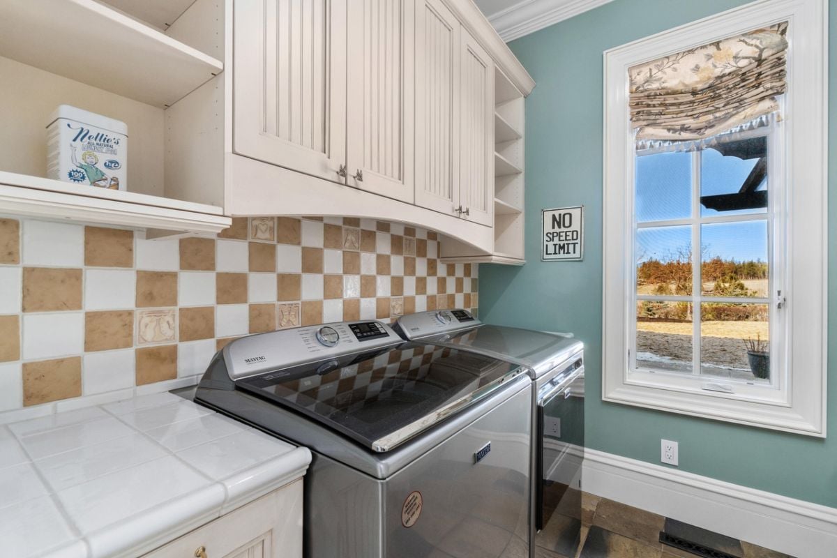 Laundry room with shelves and cabinets.