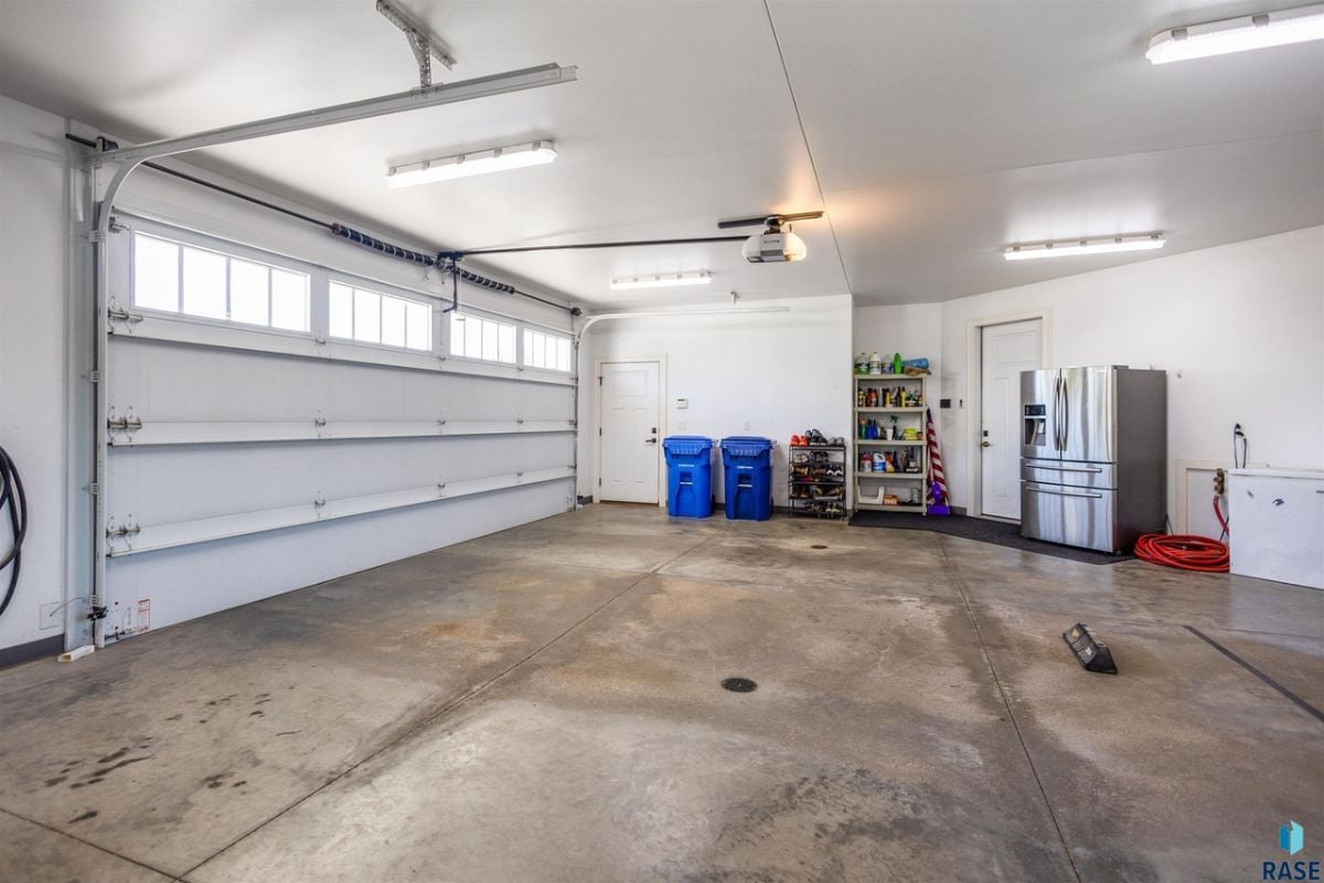 Garage with garage heater, water hook ups, and garage door opener.