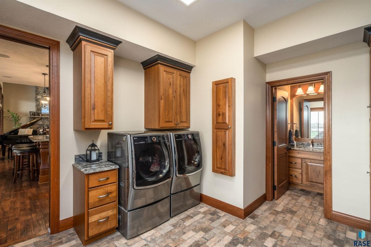 Laundry room with custom cabinetry and a sink.