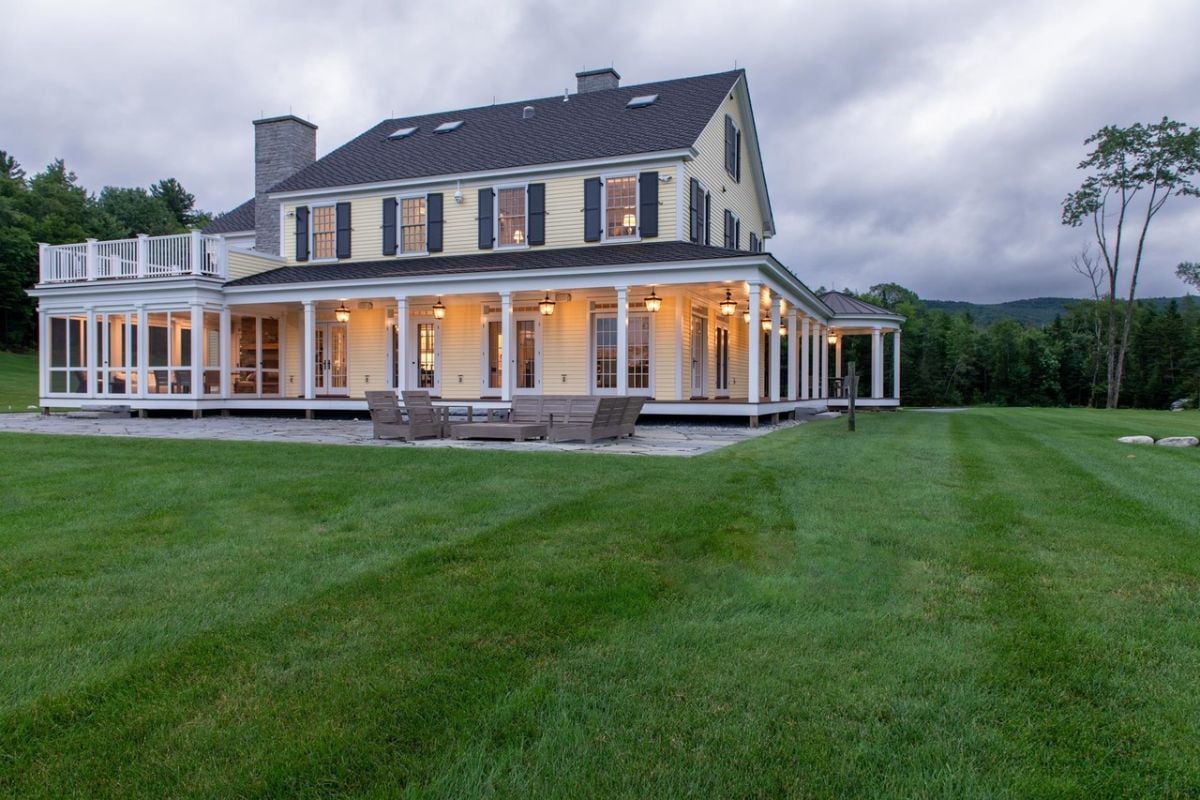 Rear view of the house with covered porch and a patio.