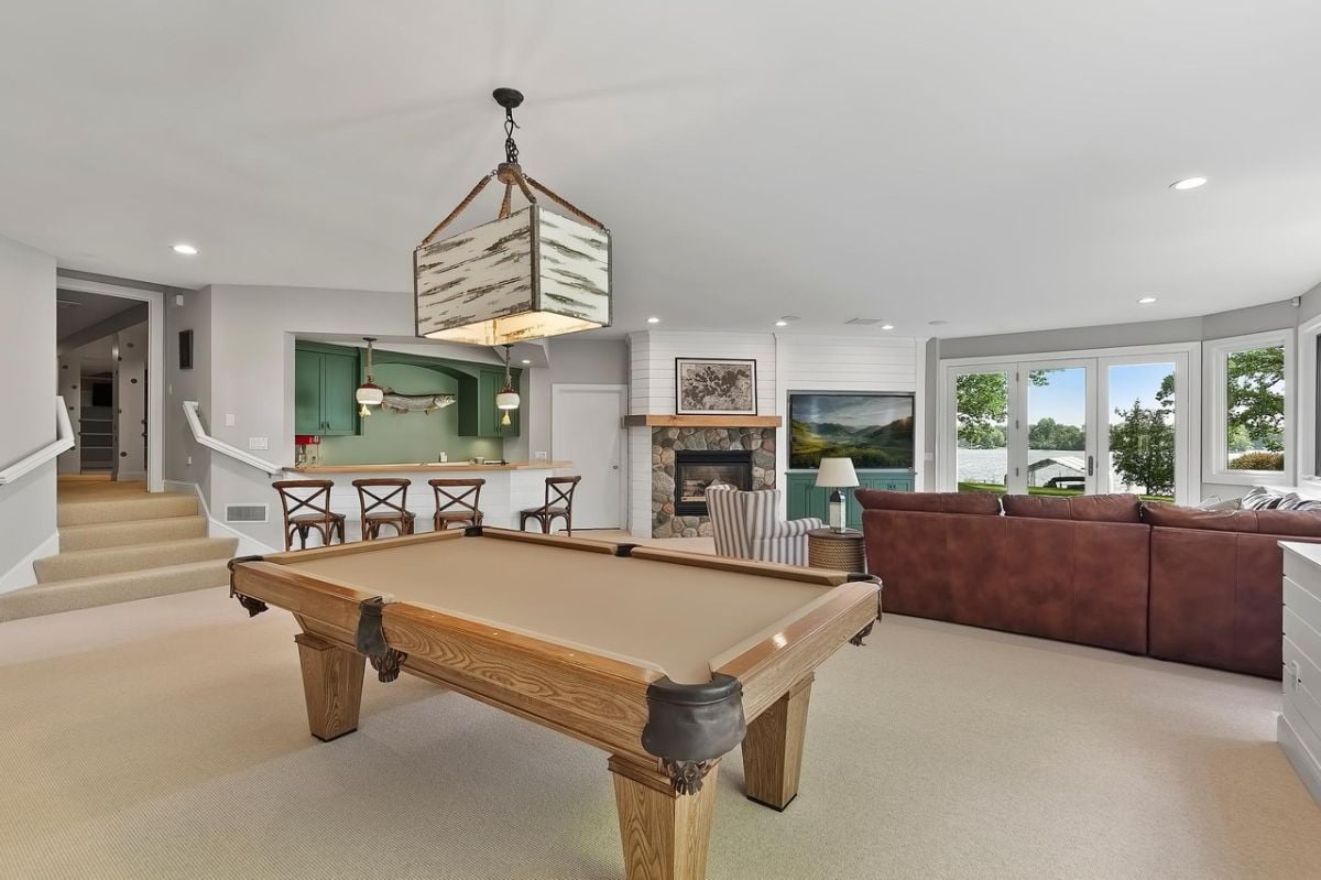 Billiard table with carpet flooring and custom lighting.