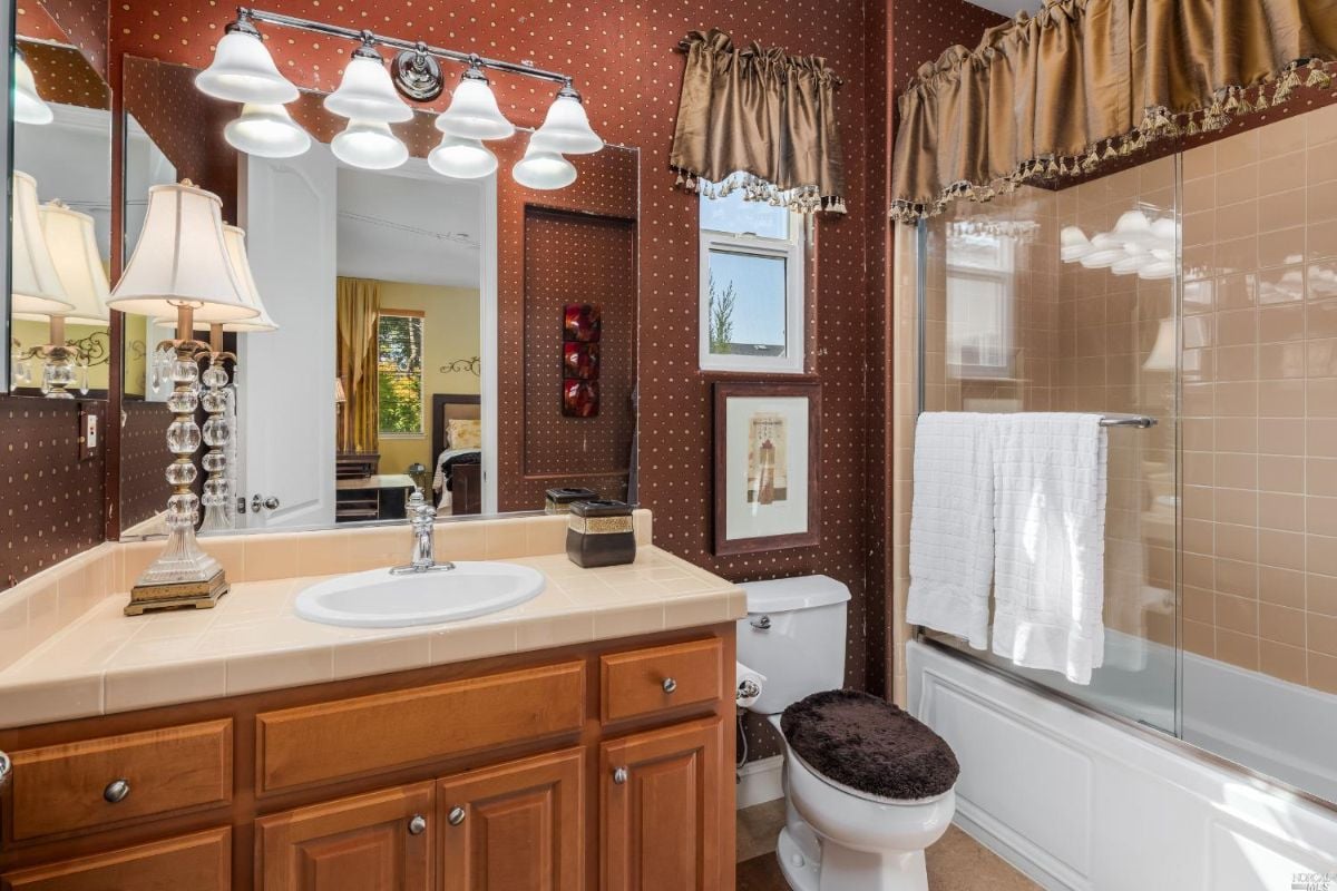 Bathroom with a sink, shower, and a toilet.