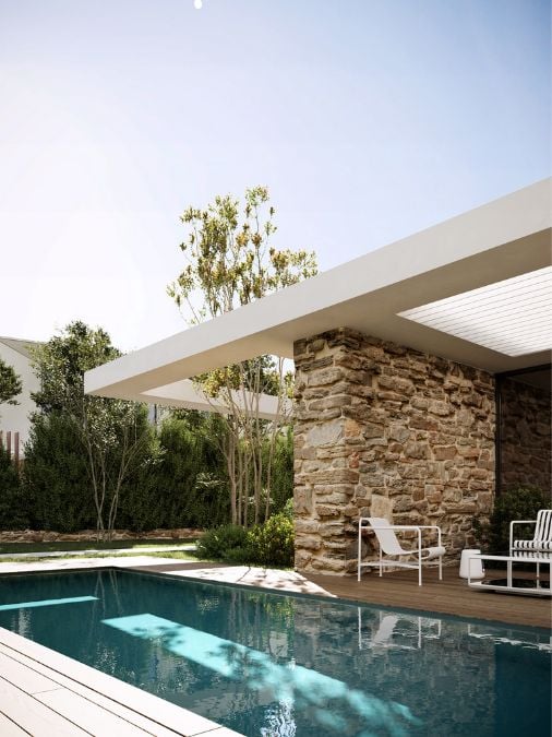 A swimming pool and covered patio with bricks wall