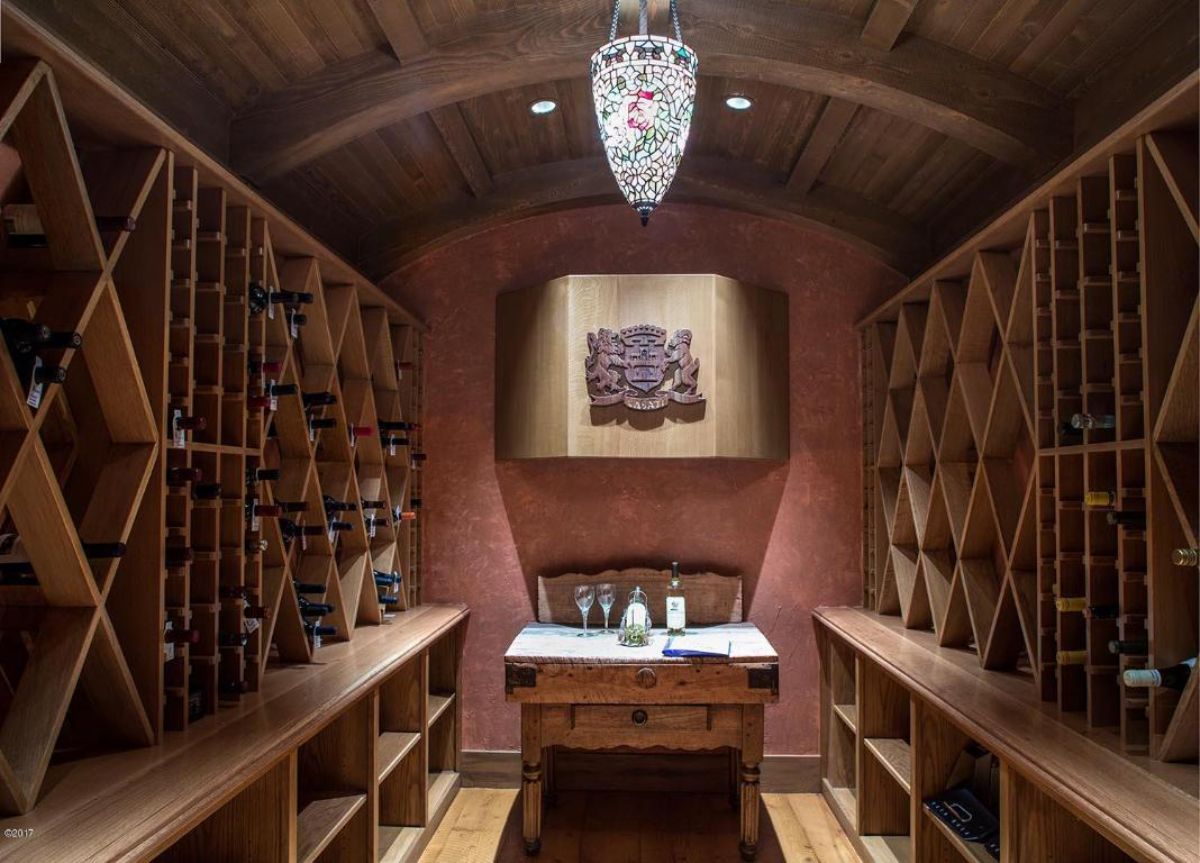 Wine cellar with wooden shelves and table.