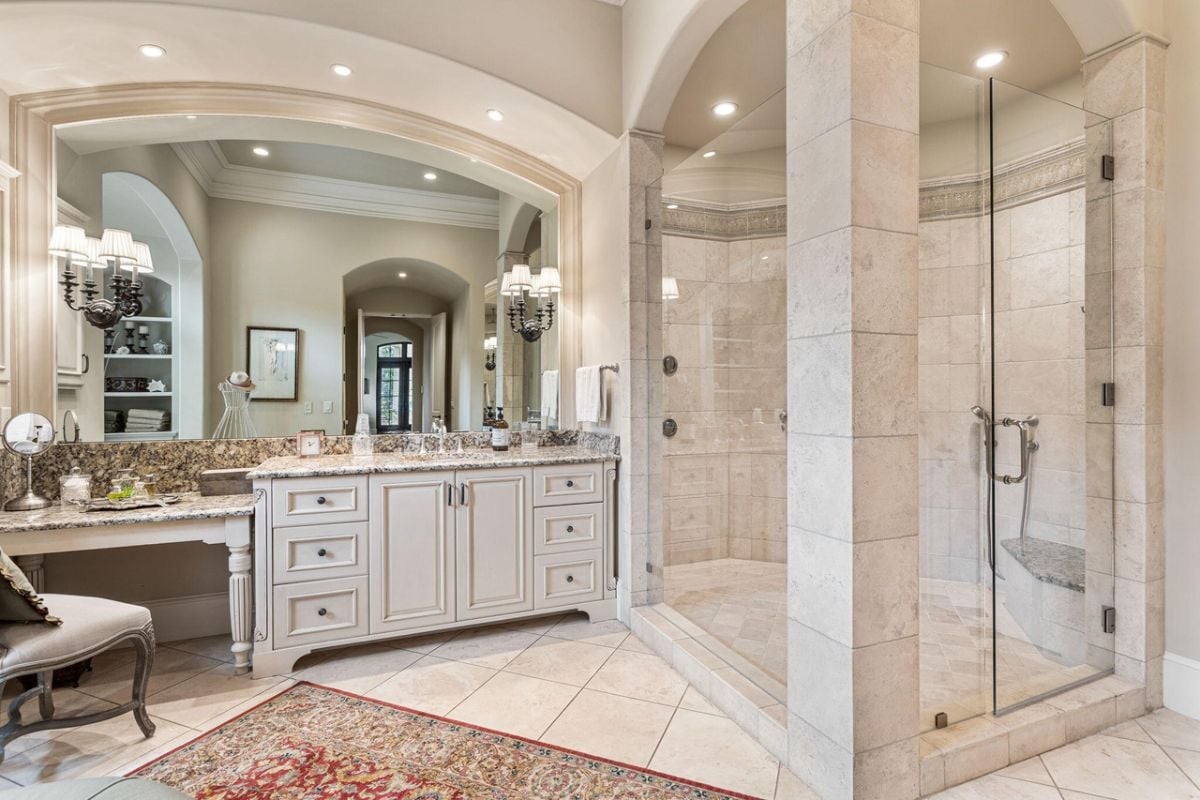 Bathroom with custom lighting, a sink, and a shower.