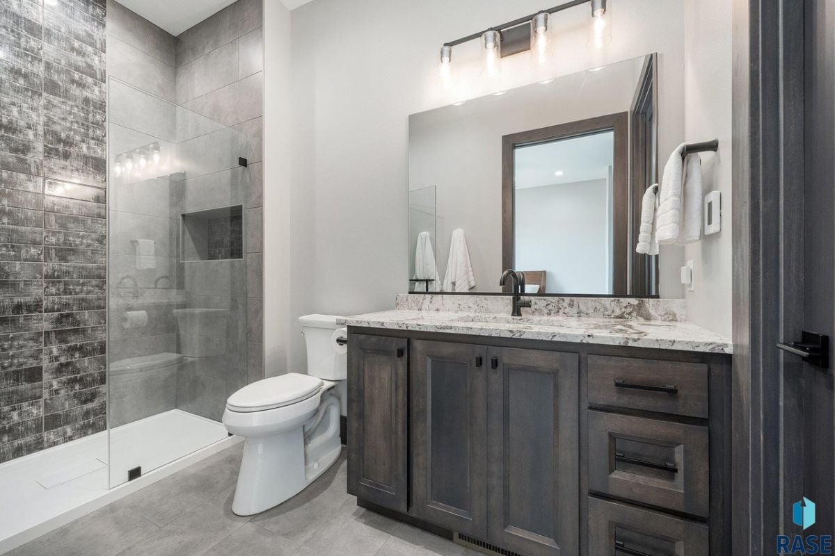 Bathroom with a sink, shower, and a toilet.