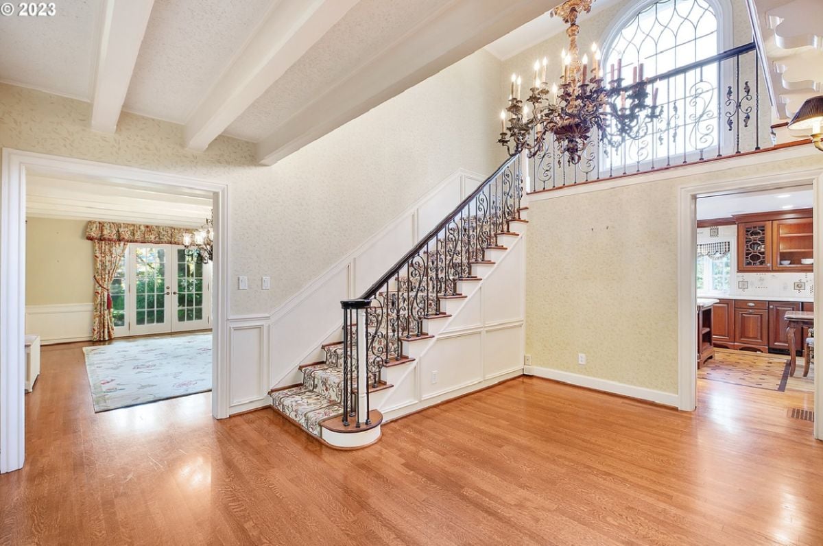 Staircase with a chandelier leading to the second level.