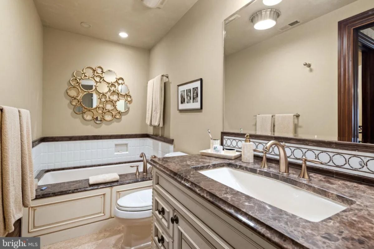 Bathroom with a sink, a soaking tub and a toilet.