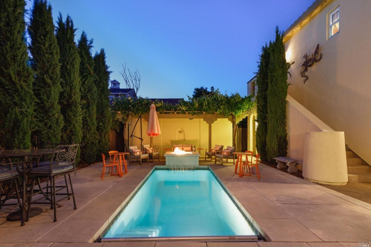 Pool with patio and chairs.