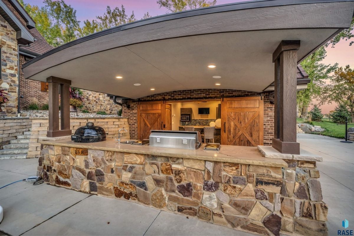 Grill area with custom lighting and wooden doors.