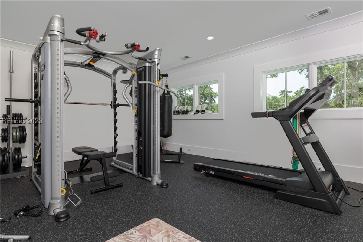 Home gym with glass windows and workout equipment.