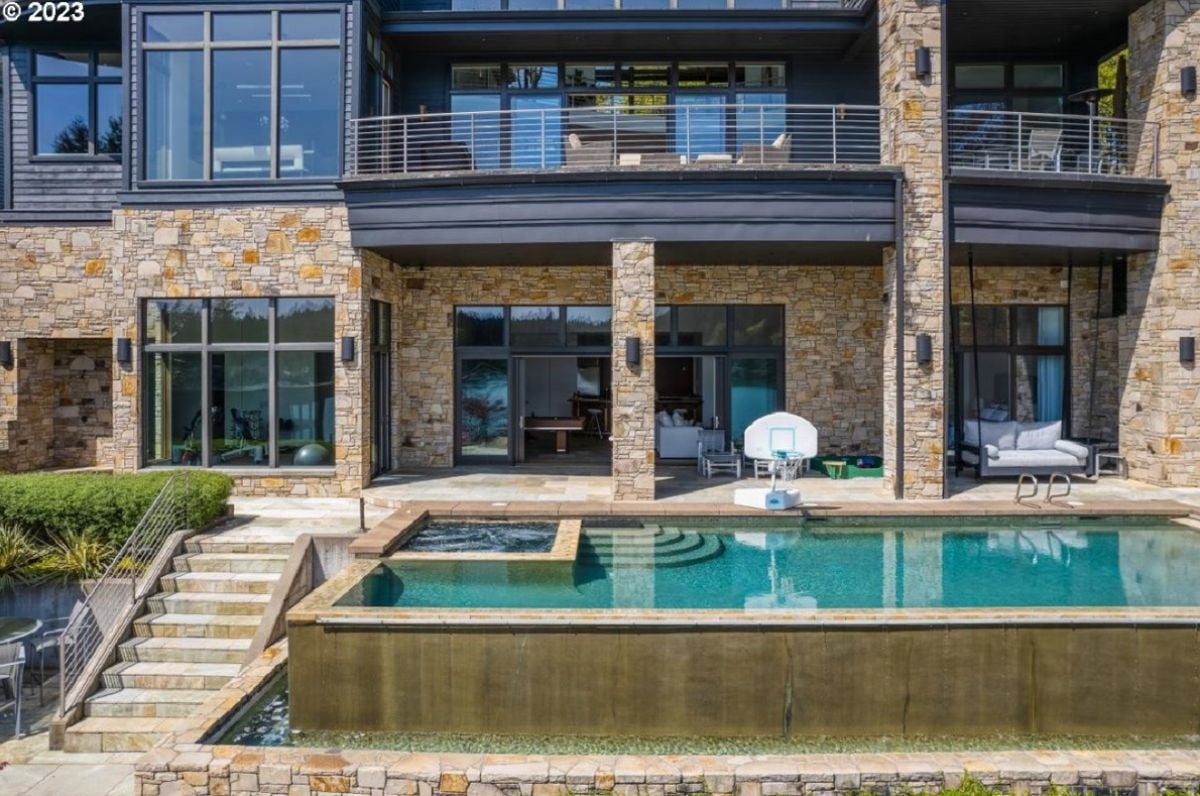 Rear view of the mansion with a pool.
