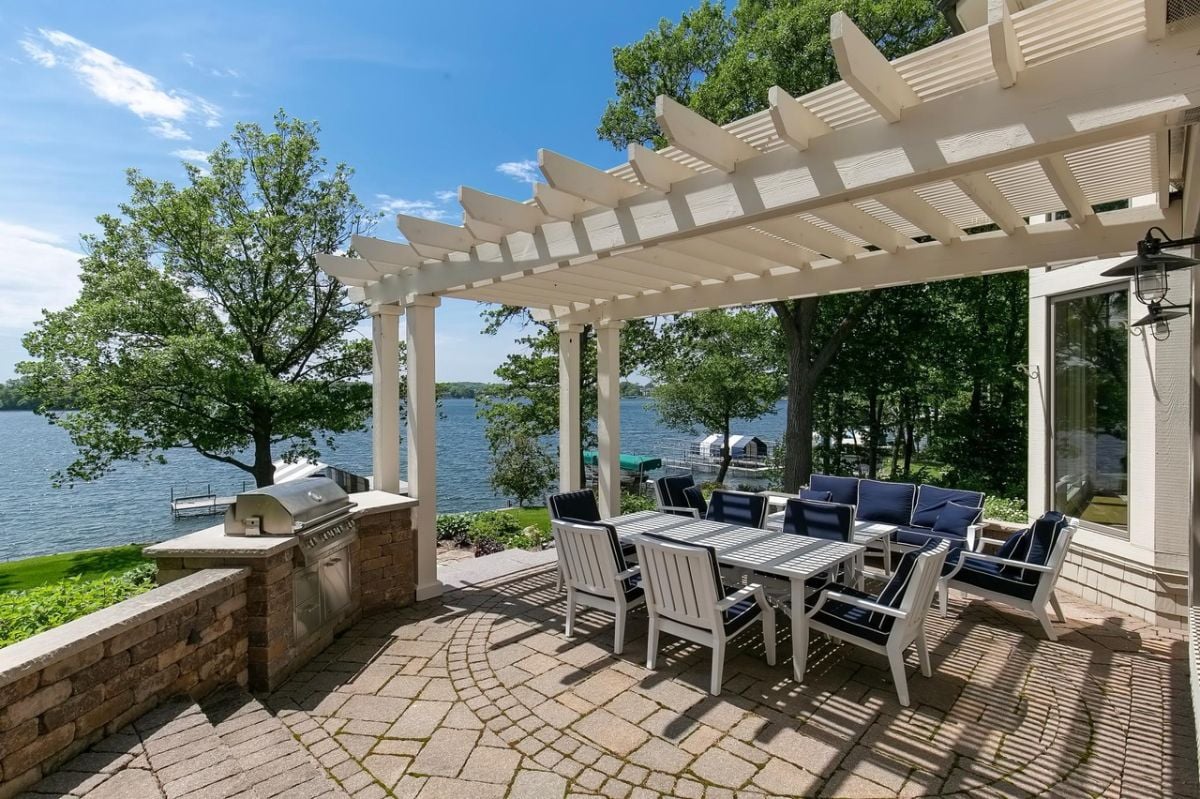 Patio with a table, chairs, and a view of the lake.