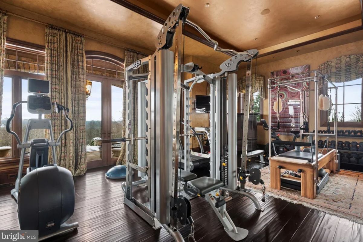 Home gym with wood flooring and workout equipment.