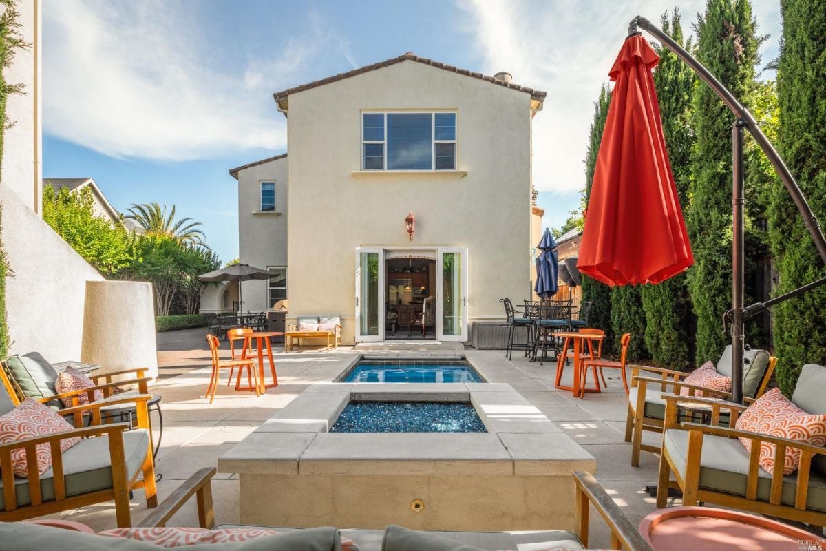 Pool with patio and chairs.