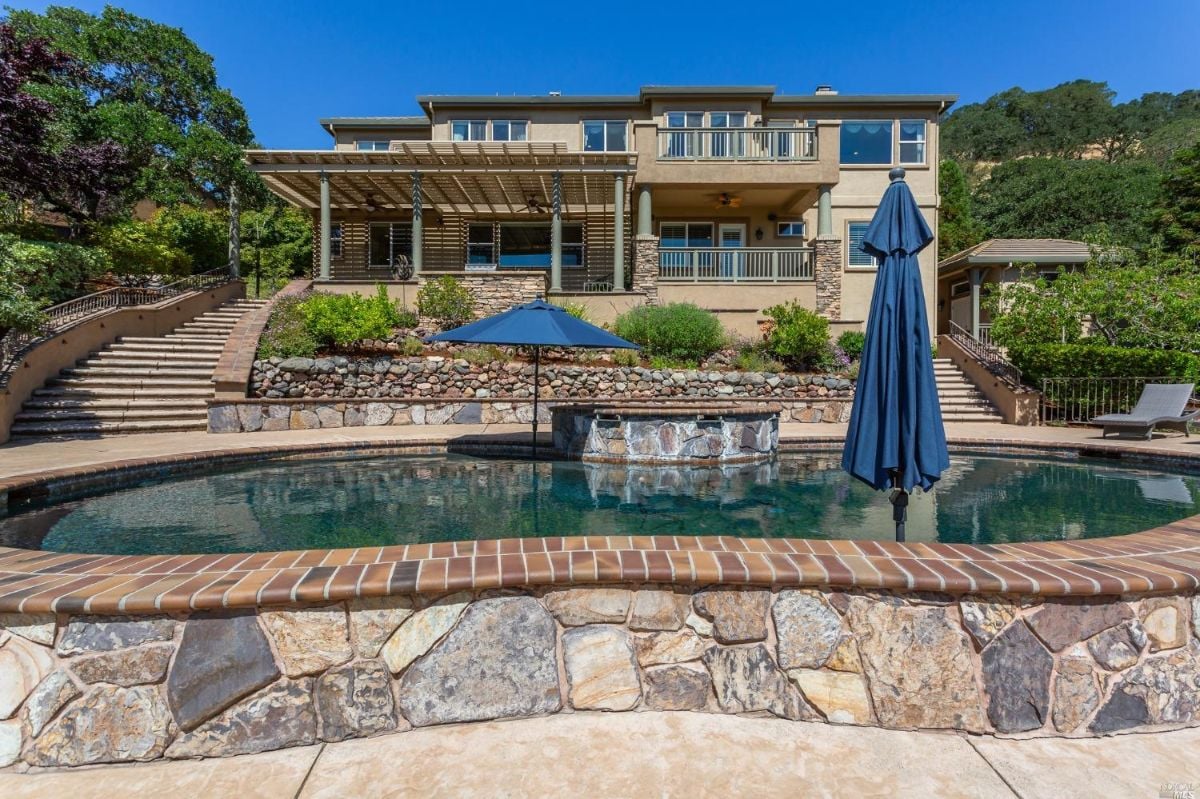 Rear view of the mansion with a pool.