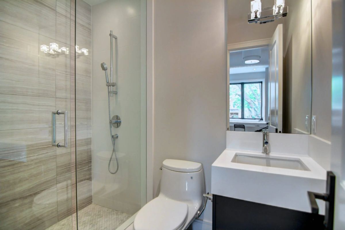 Bathroom with a sink, a shower, and a toilet.