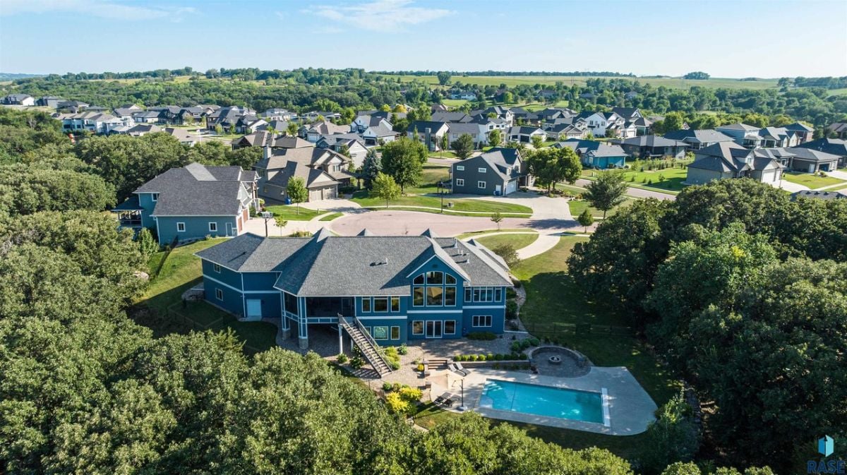 Aerial view of the property with its neighborhood in the background.