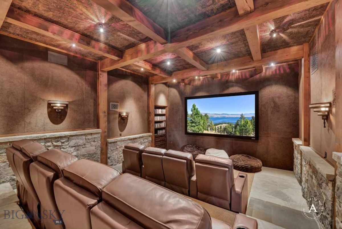 Media room with leather couches and custom lighting.