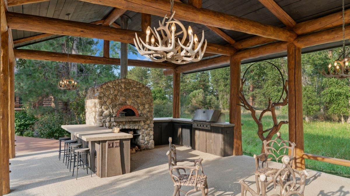 Large outdoor kitchen with a grill and a table