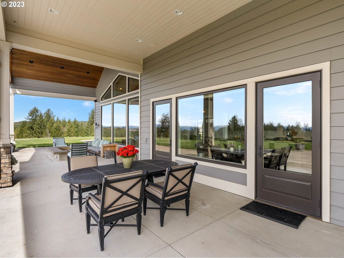 Porch with a fire pit, table and chairs.
