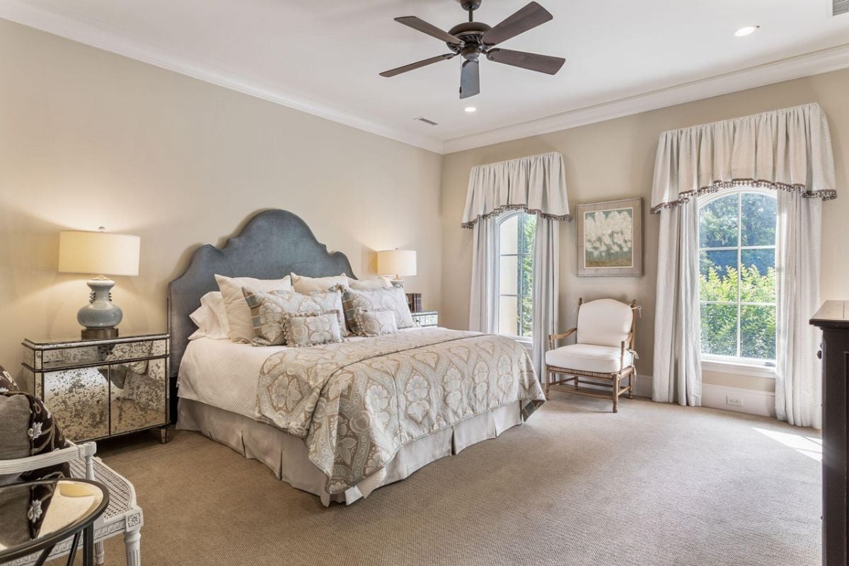 Bedroom with carpet flooring, glass windows, and custom lighting.