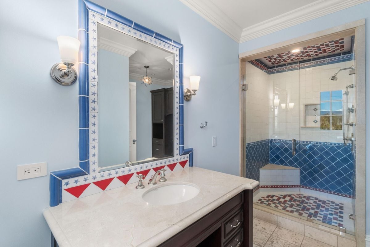Bathroom with a sink, tile flooring, and shower.