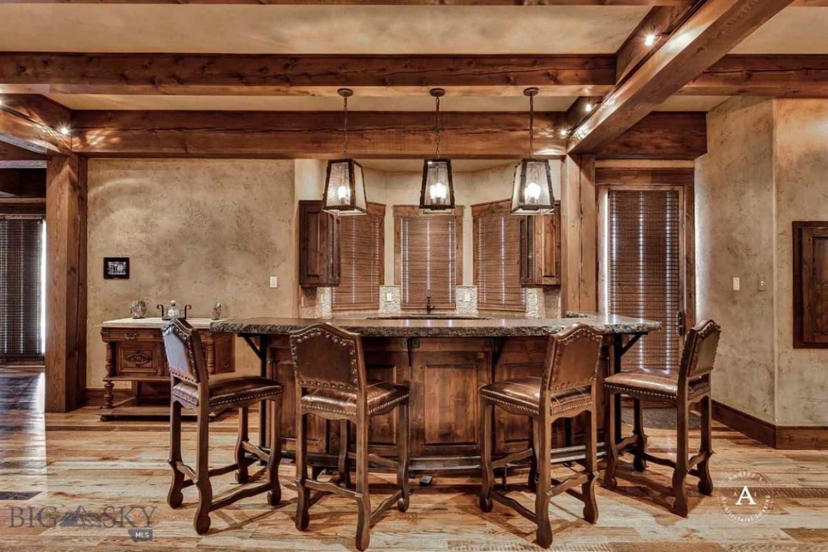 Bar with custom lighting and wooden high chairs.