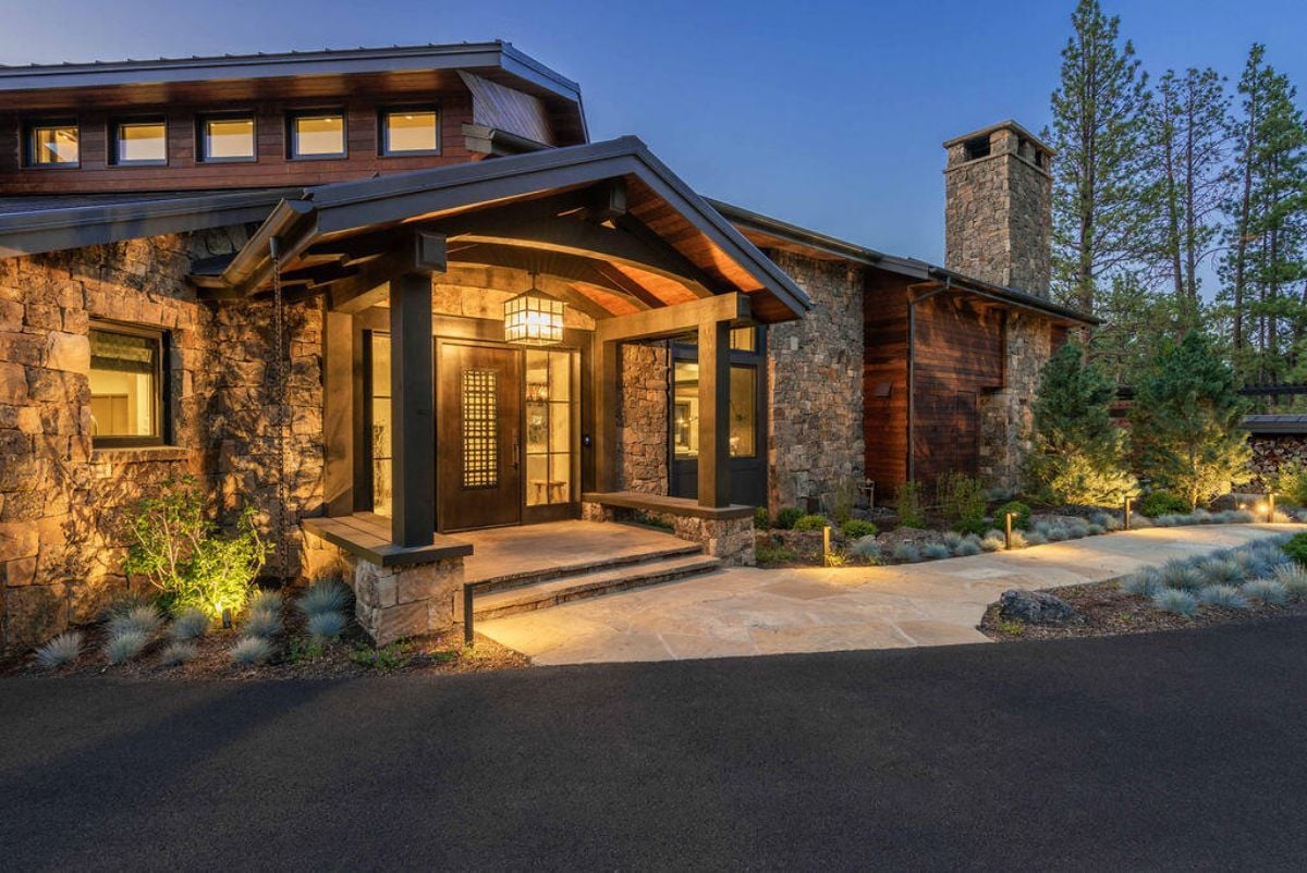 Formal entry of the house with stone and wood exterior.