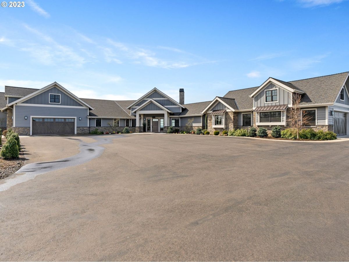 Front view of the house with a garage and a large driveway.