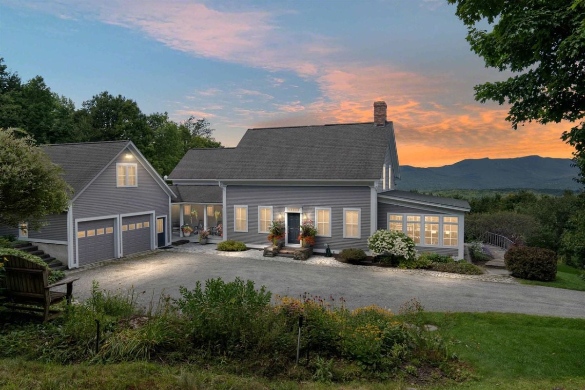 Front view of the house with a garage and a large driveway.