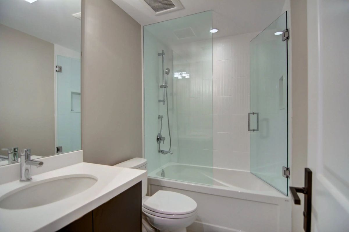 Bathroom with a sink, shower, and a toilet.