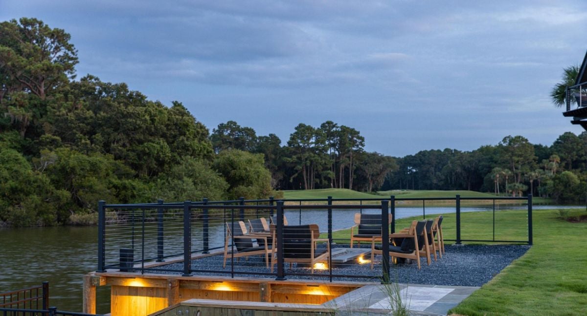 Fire pit with chairs and a view of the water.