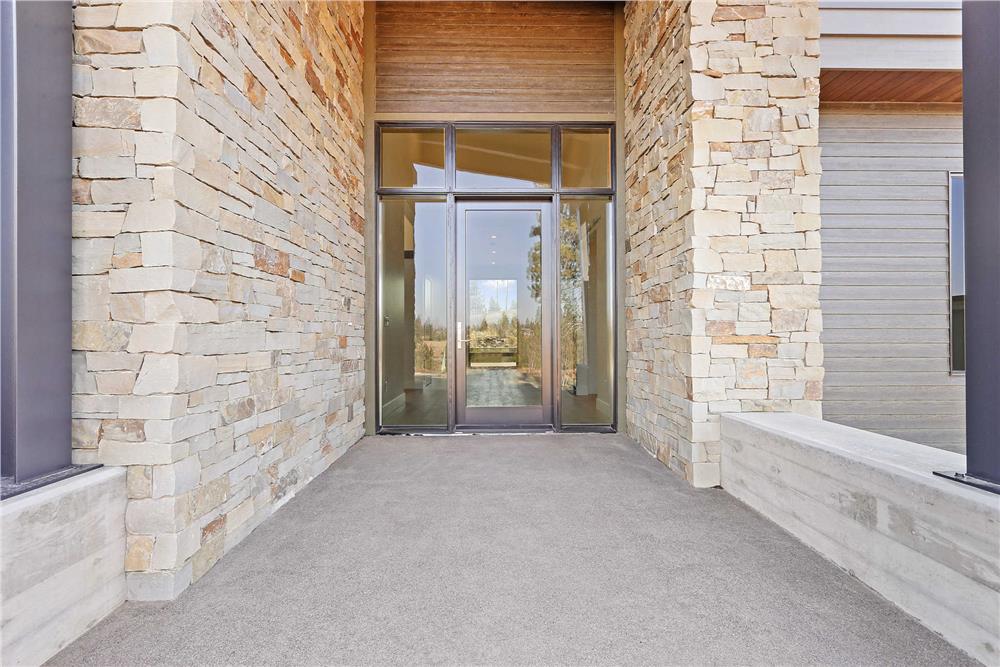 A closer look of the front entry showcasing the glazed front door.