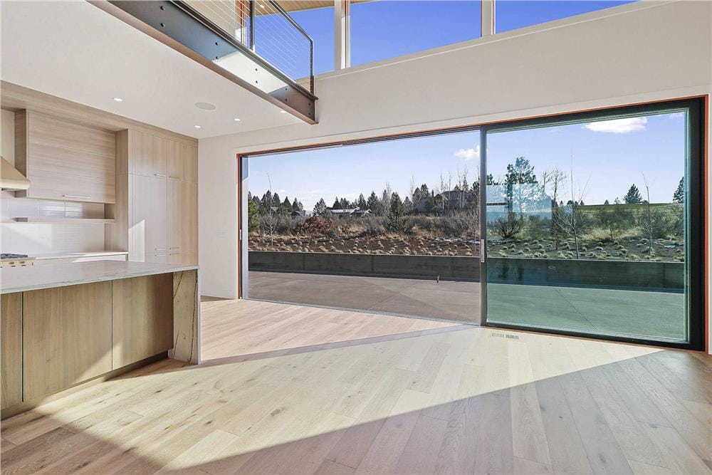 Oversized sliding glass doors extend the great room and kitchen onto the outdoor living.