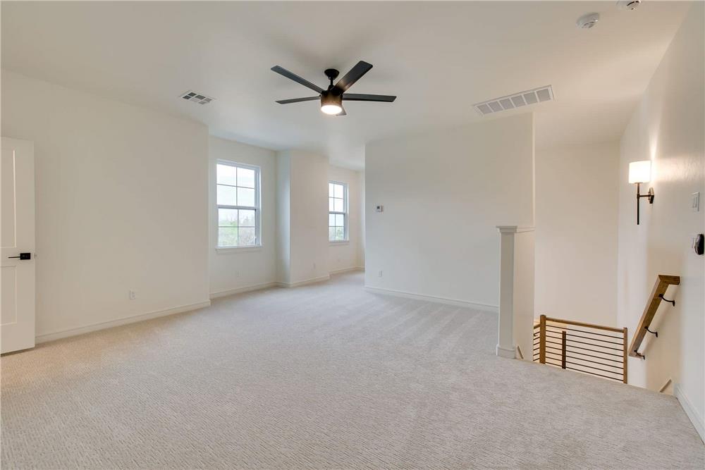 Game room with carpeted flooring and a ceiling fan.
