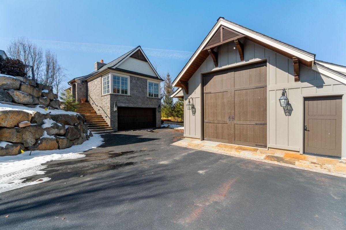 Garage with a large paved driveway.