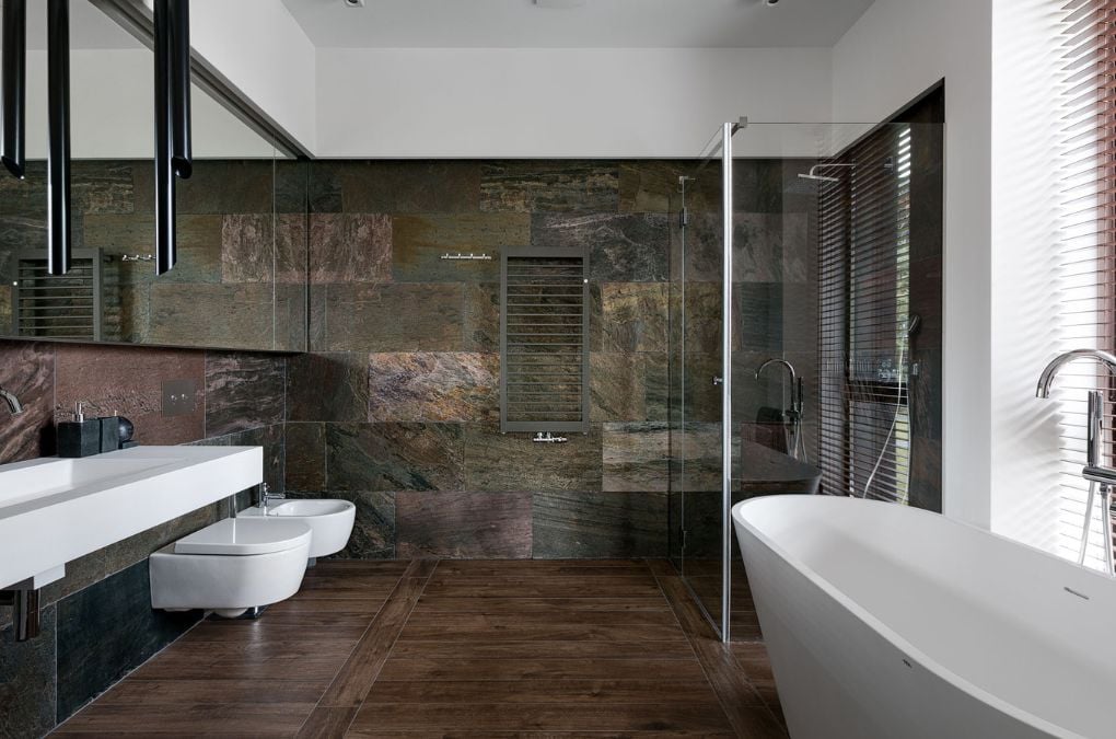A bathroom with a large bathtub next to a sink