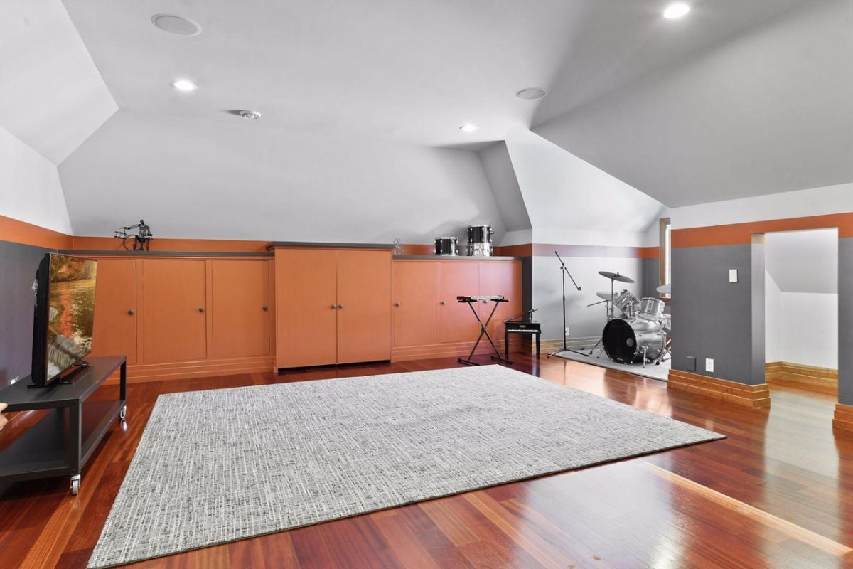 Music room with musical instruments and a TV.