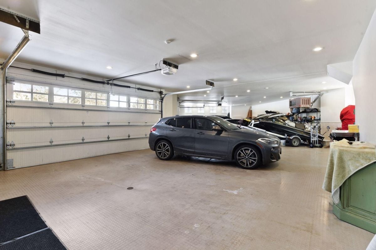 Spacious garage with custom lighting and automatic door opener.
