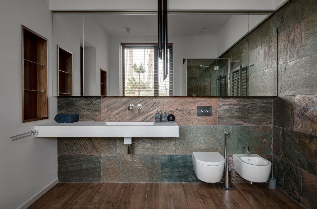 A bathroom with a sink, toilet and mirror