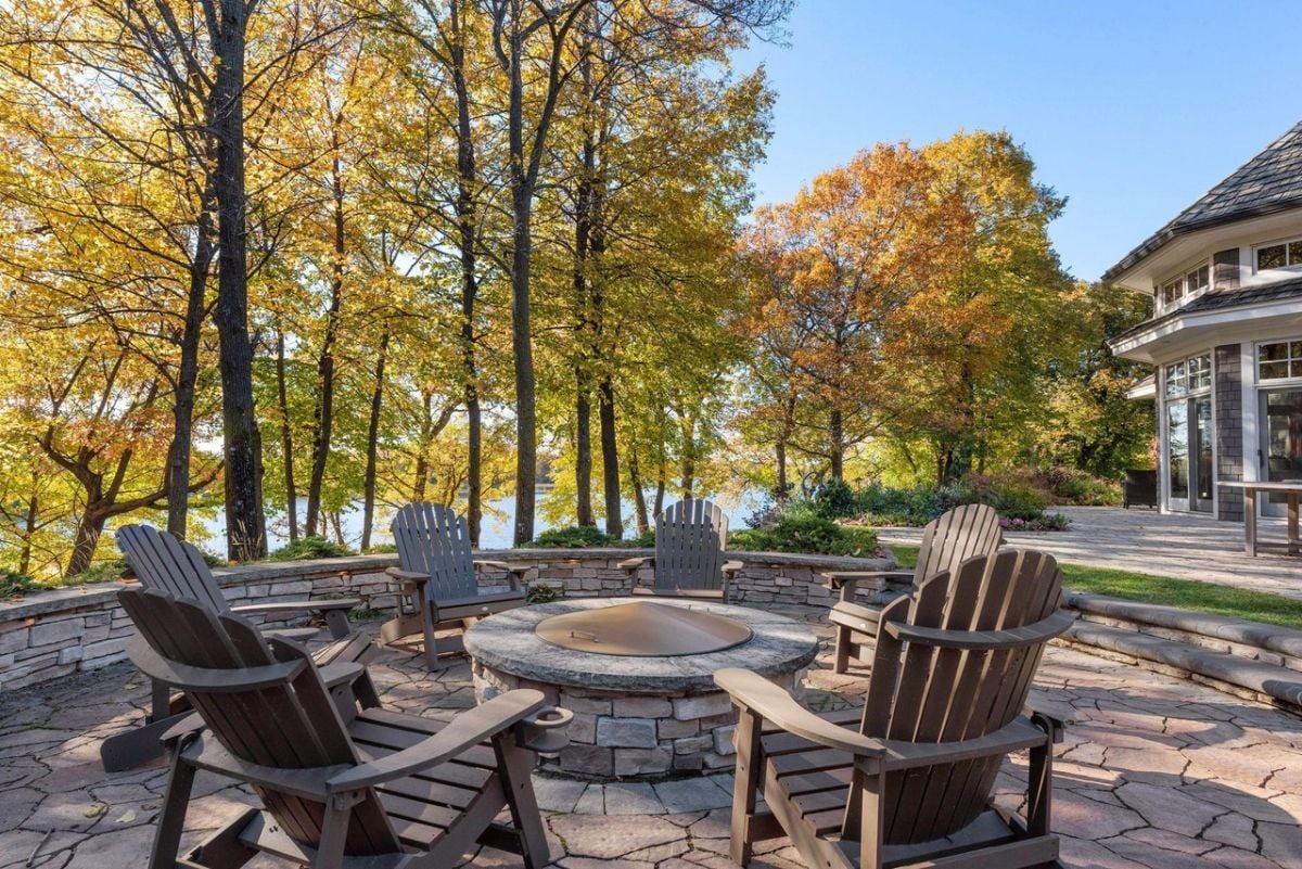 Patio with a fire pit and a view of the lake.