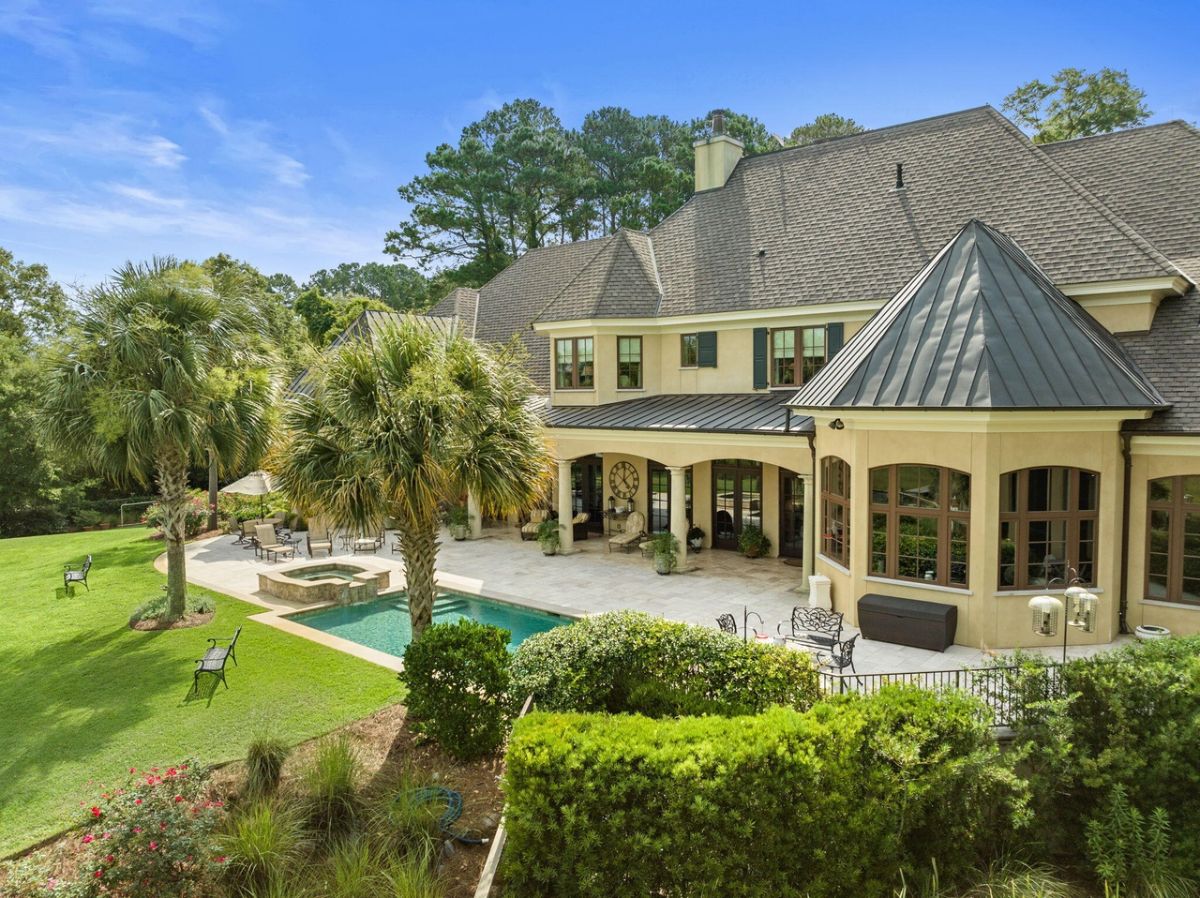 Rear view of the mansion with a pool.