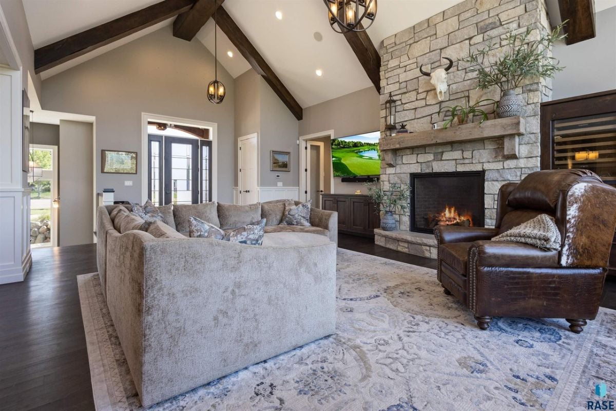 Living room with couches, Vaulted Ceiling, a fireplace and a TV.