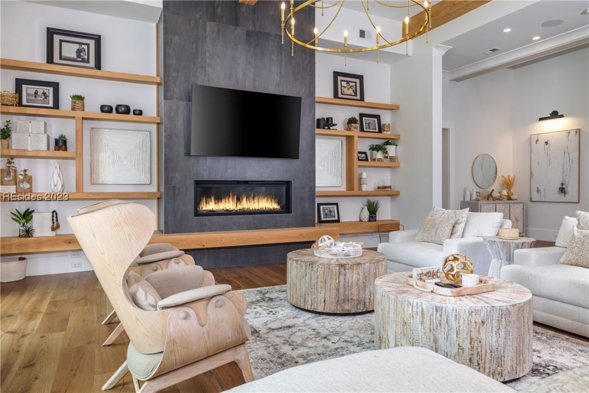 Living room with couches, a fireplace and a chandelier.