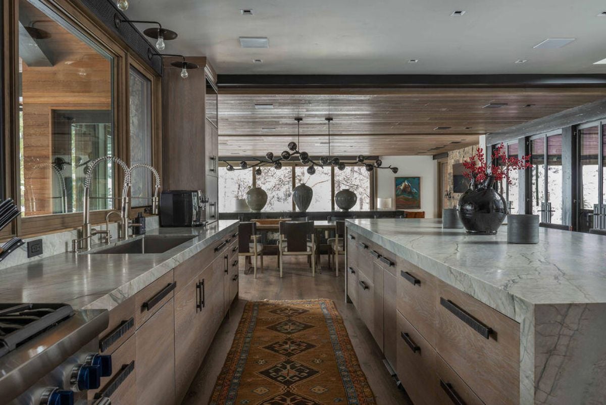 Kitchen with granite countertops, a large island, and custom cabinetry.