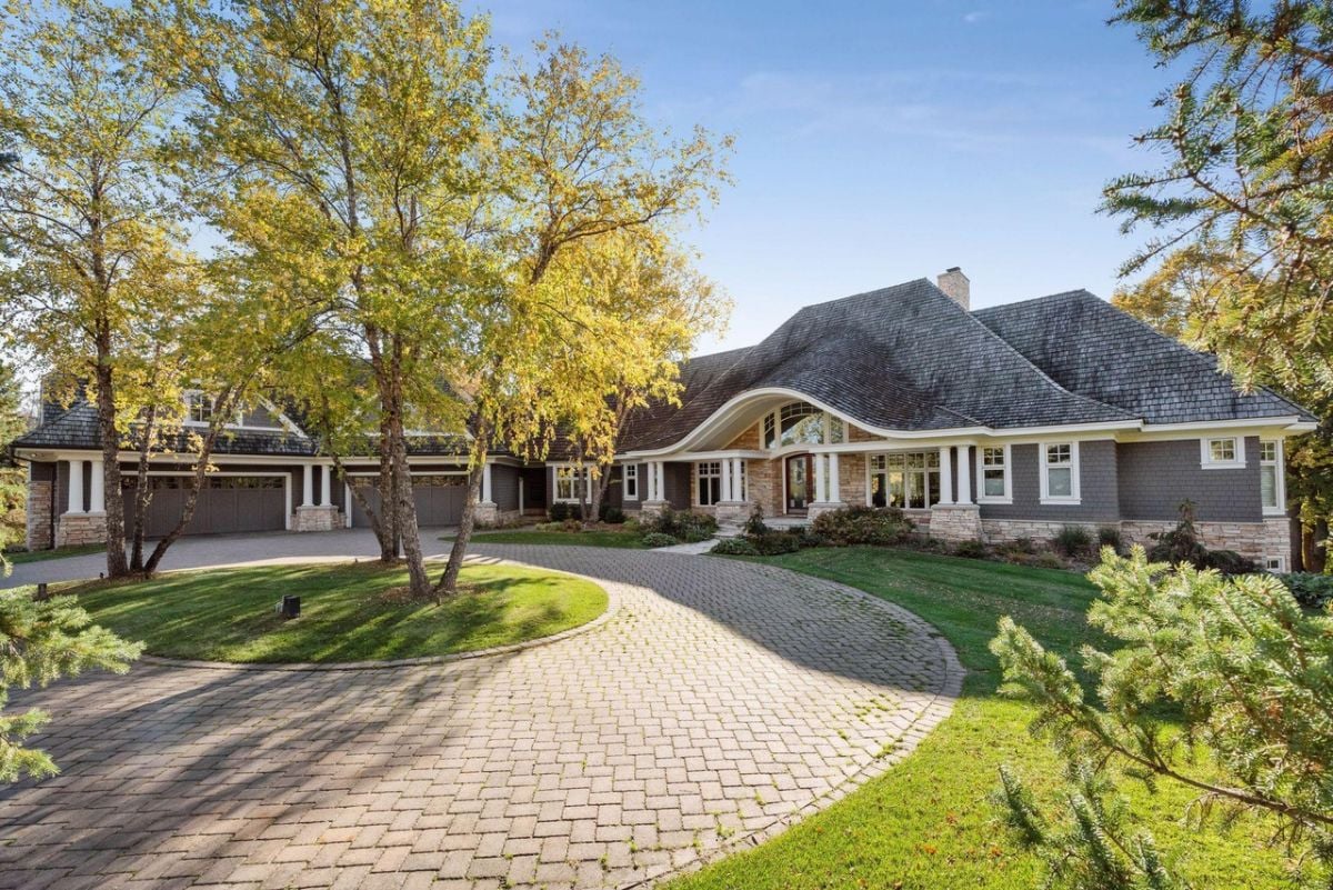 Front view of the mansion with a large driveway.