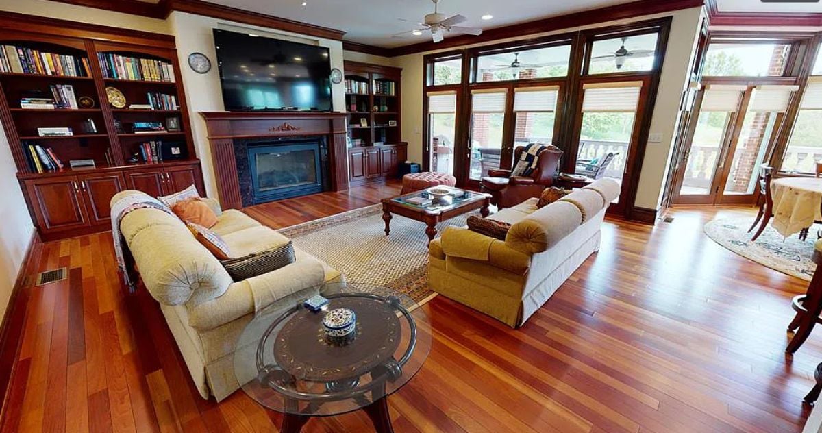 Living room with couches, a TV, and a fireplace.
