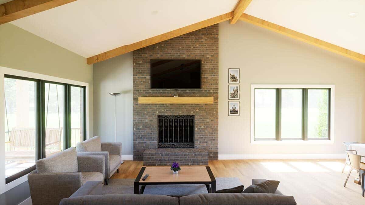 Family room with modern seats and a stone fireplace topped with a TV.