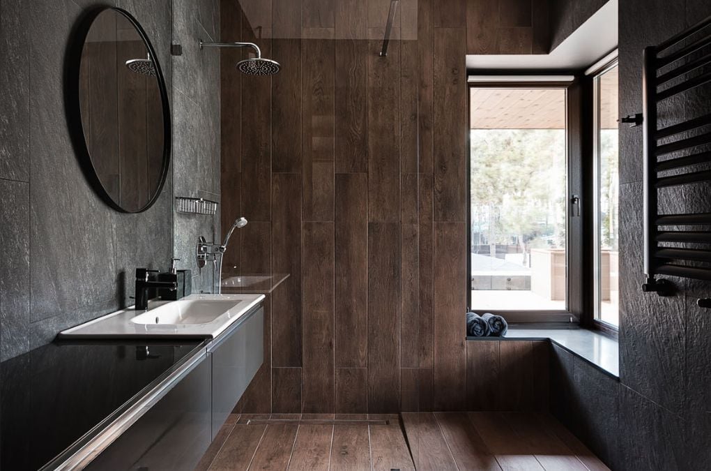 A bathroom with a wooden wall and a sink